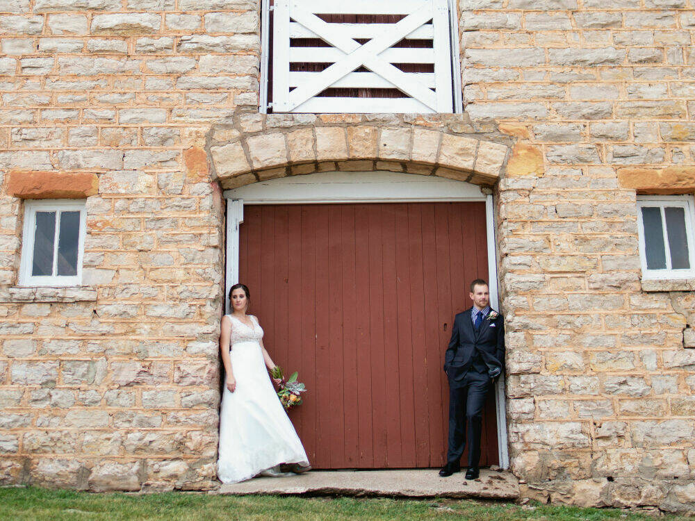 Bride & Groom in front of one of Courtyard Barns red barn doors